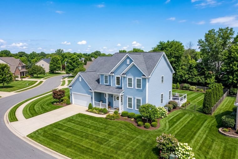 Aerial drone photo of a blue colonial home on Long Island